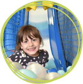 Girl in soft play ball pool